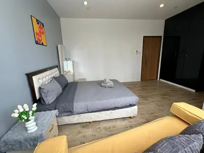 a bedroom with a bed and a couch and a tv at Spacious Chill Entire Suites 118Island Plaza in George Town