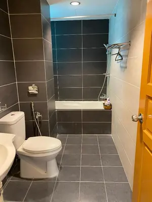 a bathroom with a toilet and a sink and a shower at 11th Sky Kinta Riverfront with Wi-Fi in Ipoh