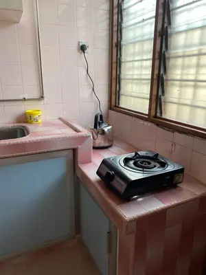 a kitchen with a stove top on a counter at Staycation Taiping Homestay in Taiping