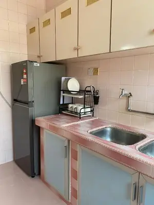 a kitchen with a sink and a refrigerator at Staycation Taiping Homestay in Taiping