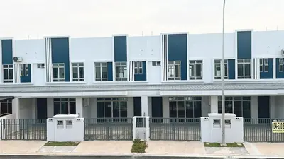 a white building with blue and black windows and a street at 2 Bedroom Townhouse Homestay In Bandar Dato Onn in Gua Sai