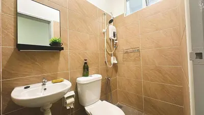 a bathroom with a white toilet and a sink at 2 Bedroom Townhouse Homestay In Bandar Dato Onn in Gua Sai