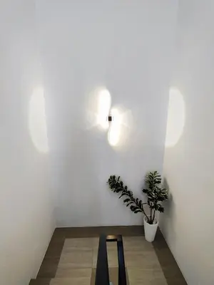 a room with a table and a plant on a wall at 2Op Ipoh, Semi D, in Ipoh