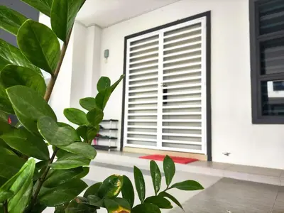 a room with a large window and a plant at 2Op Ipoh, Semi D, in Ipoh