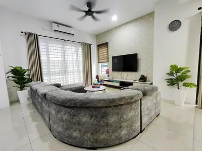 a living room with a large couch and a tv at 2Op Ipoh, Semi D, in Ipoh