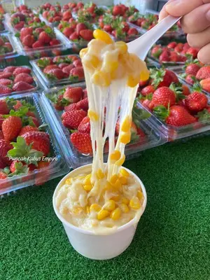 a person is eating a bowl of food with a spoon at Lily Studio in Brinchang