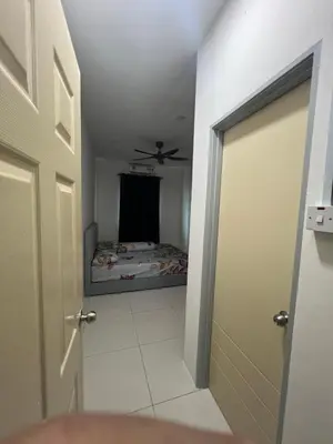 a hallway with a bed in a room with a door at Homestay Behrang Sentral in Kampung Behrang