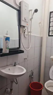 a bathroom with a sink and a shower at Anjung Vacation Home No 70 in Gua Sai