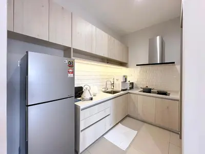 a kitchen with a refrigerator and a sink at Iconic Regency by Li in Gelugor