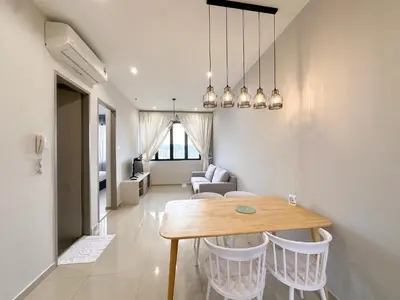 a dining room and living room with a table and chairs at Iconic Regency by Li in Gelugor