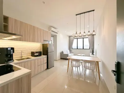 a kitchen with a table and chairs in a room at Iconic Regency by Li in Gelugor