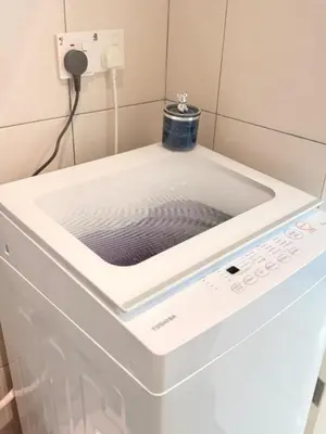 a washer and dryer in a room at The Sun Executive Suite - Dolphin's Home in Bayan Lepas