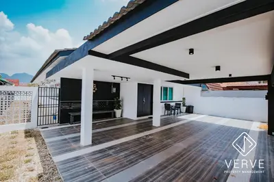 a patio with white walls and a wooden floor at Ipoh Lazy Private Club House 4B3B by Verve 14 pax in Tambun
