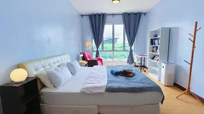 a bedroom with a large bed and a window at PPAM Seruling Presint 5, Putrajaya 4BR with PICC View and Garden View Homestay