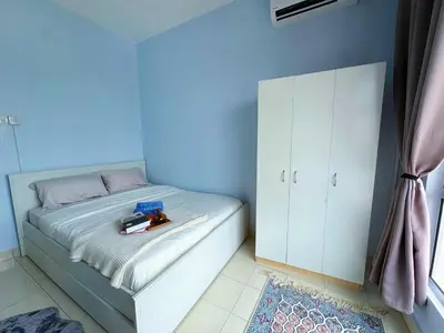 a bedroom with a bed with a blue wall at PPAM Seruling Presint 5, Putrajaya 4BR with PICC View and Garden View Homestay