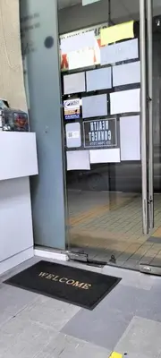 a door with a welcome mat in front of a store at Housing Help in Kepala Batas