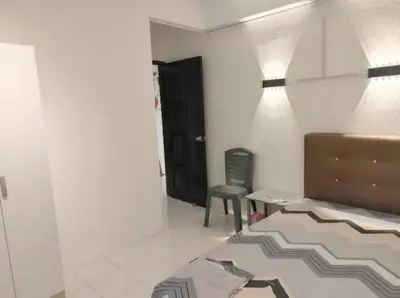 a room with a bed and a desk and a chair at Comfy Room Near to Penang Bridge in George Town
