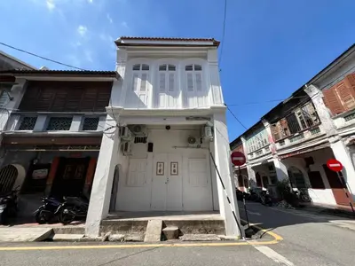 a white building with a white door on a street at Carnarvon 73 in George Town