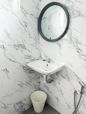 a bathroom with a sink and a mirror on the wall at NAR Kampung Studio in Bayan Lepas