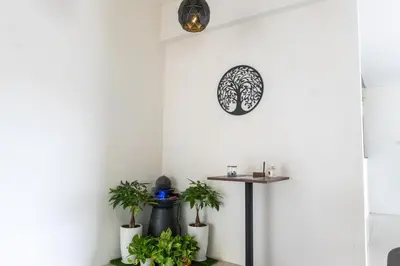a room with plants and a clock on the wall at Leavy Haven, Botanica CT, Balik Pulau, Penang in Balik Pulau