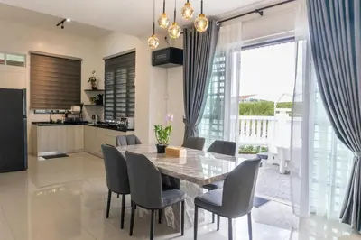 a kitchen and dining room with a table and chairs at Leavy Haven, Botanica CT, Balik Pulau, Penang in Balik Pulau