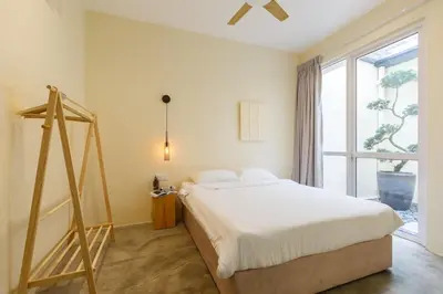 a bedroom with a bed and a large window at De Luma-Cozy 2Bedroom Landed House, Bukit Mertajam in Bukit Mertajam