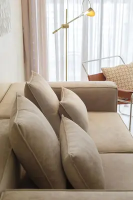 a couch with pillows on it in a living room at De Luma-Cozy 2Bedroom Landed House, Bukit Mertajam in Bukit Mertajam