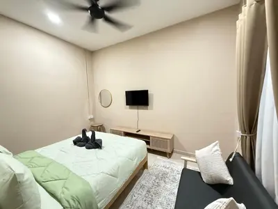a bedroom with a bed and a ceiling fan at Rumah No 5 in Taiping
