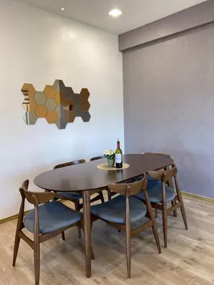 a dining room table with chairs and a bottle of wine at The Venus Sweet home in Sitiawan
