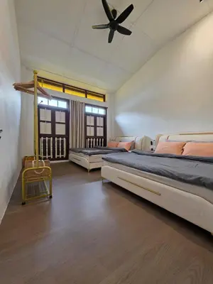 a bedroom with two beds and a ceiling fan at New ! 6 Pax Georgetown Heritage Pre-war House 2 Bed Room in George Town