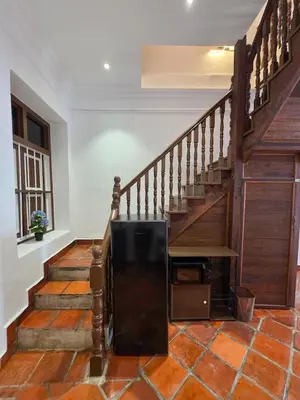 aoyer with a wooden staircase with a television on it at New ! 6 Pax Georgetown Heritage Pre-war House 2 Bed Room in George Town