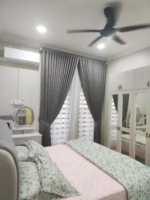 a bedroom with a bed and a ceiling fan at Homestay Saujana Hill in Gua Musang