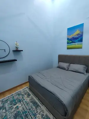 a bed in a room with a blue wall at Homestay Saujana Hill in Gua Musang