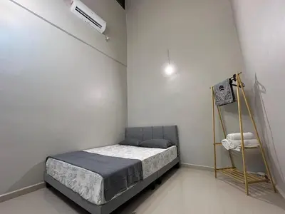 a small bedroom with a bed and a shelf at Peruda Inn - Homestay for Múslim only in Sungai Petani