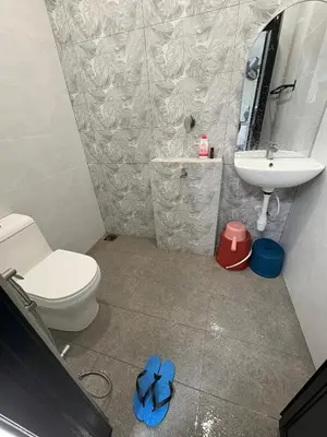 a bathroom with a toilet and a sink at Peruda Inn - Homestay for Múslim only in Sungai Petani