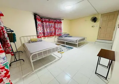 a room with two beds and a window at Robina Homestay in Butterworth
