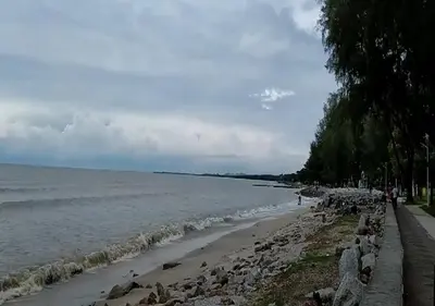 a beach with rocks and the ocean on a cloudy day at Robina Homestay in Butterworth