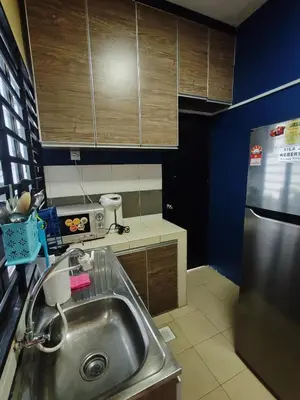 a kitchen with a sink and a stainless steel refrigerator at ZE I Cameron Jaya, Tanah Rata in Tanah Rata