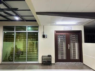a entrance to a building with a brown door at Mumtaz Homestay in Kampong Belah Dua