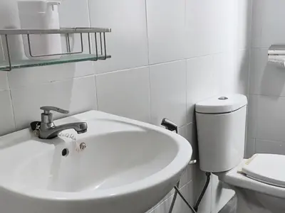 a white bathroom with a sink and a toilet at Majestic Sanctuary Homestay Taiping with Netflix - 2 Carpark in Taiping