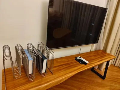 a living room with a tv and a wooden table at Urban Suites Georgetown Penang - Affordable & Cozy Stay with High Floor-Sea & Penang Bridge View in George Town