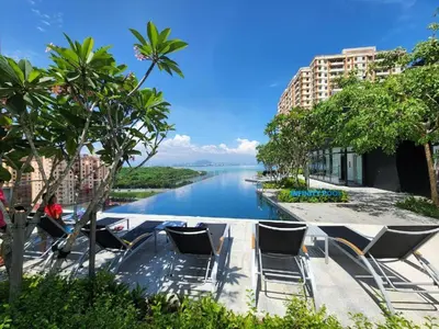 a view of a river with chairs and buildings at Urban Suites Georgetown Penang - Affordable & Cozy Stay with High Floor-Sea & Penang Bridge View in George Town