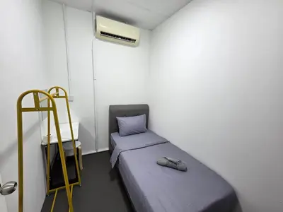 a small room with two beds and a ladder at The Ipohstay hostel in Ipoh