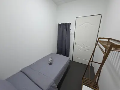 a room with a bed and a ladder and a mirror at The Ipohstay hostel in Ipoh