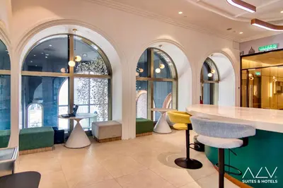 a lobby with a counter and chairs and windows at 22 Macalisterz by ALV in George Town