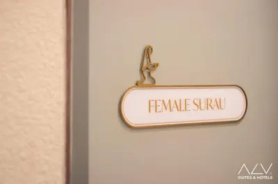 a sign hanging on a door with the words female sunu at 22 Macalisterz by ALV in George Town