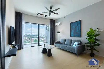 a living room with a couch and a ceiling fan at Sunshine Residence Suites in Ayer Itam
