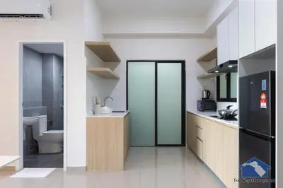 a kitchen with a refrigerator and a toilet in it at Sunshine Residence Suites in Ayer Itam