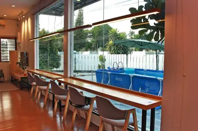 a bar with a row of chairs and a sink at The Nook Holiday Home Cozy, Stylish, Swimming Pool in Ipoh