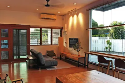 a living room with a couch and a tv at The Nook Holiday Home Cozy, Stylish, Swimming Pool in Ipoh